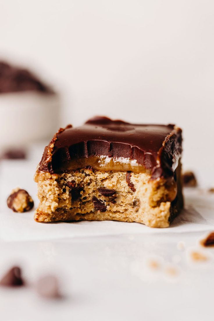 two pieces of cake sitting on top of a white plate with chocolate chips around it