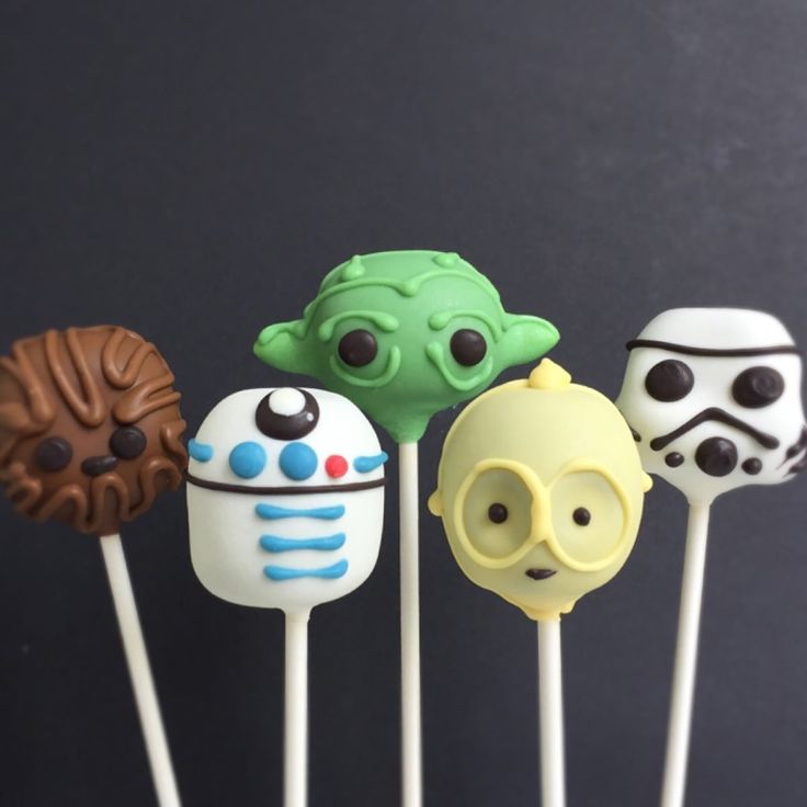 star wars cake pops are lined up in a row with the faces of characters on them