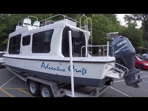 a white and blue boat parked in a parking lot