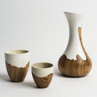 three white and brown vases sitting next to each other