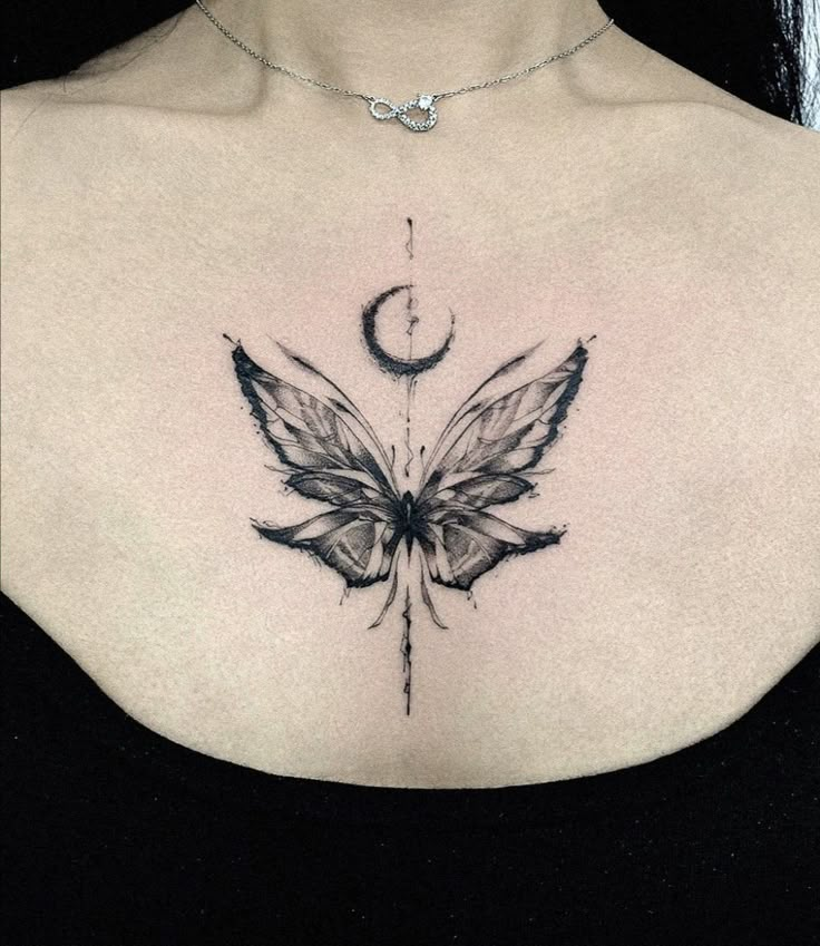 a woman's chest with a butterfly and crescent tattoo on the left side of her chest