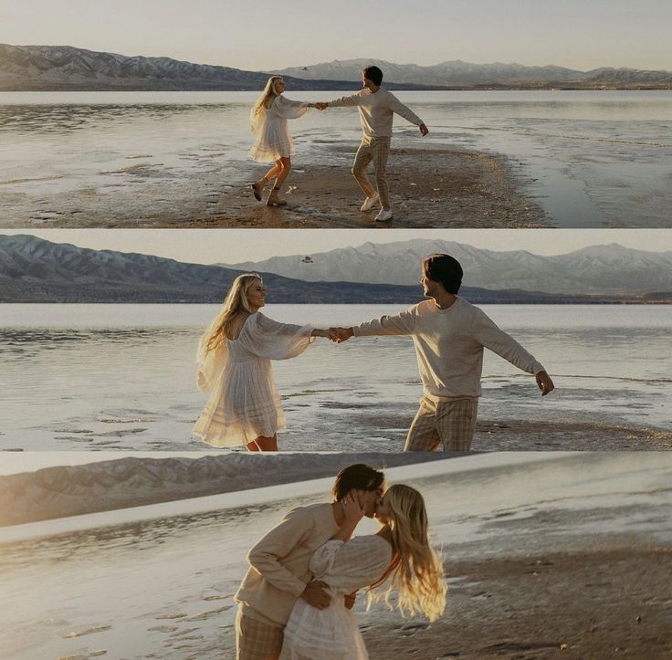 two people holding hands on the beach with mountains in the background and one person kissing the other