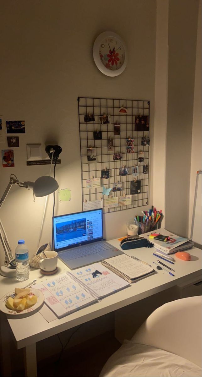 a laptop computer sitting on top of a white desk