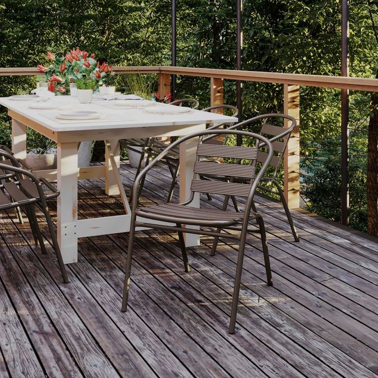 an outdoor table and chairs on a wooden deck