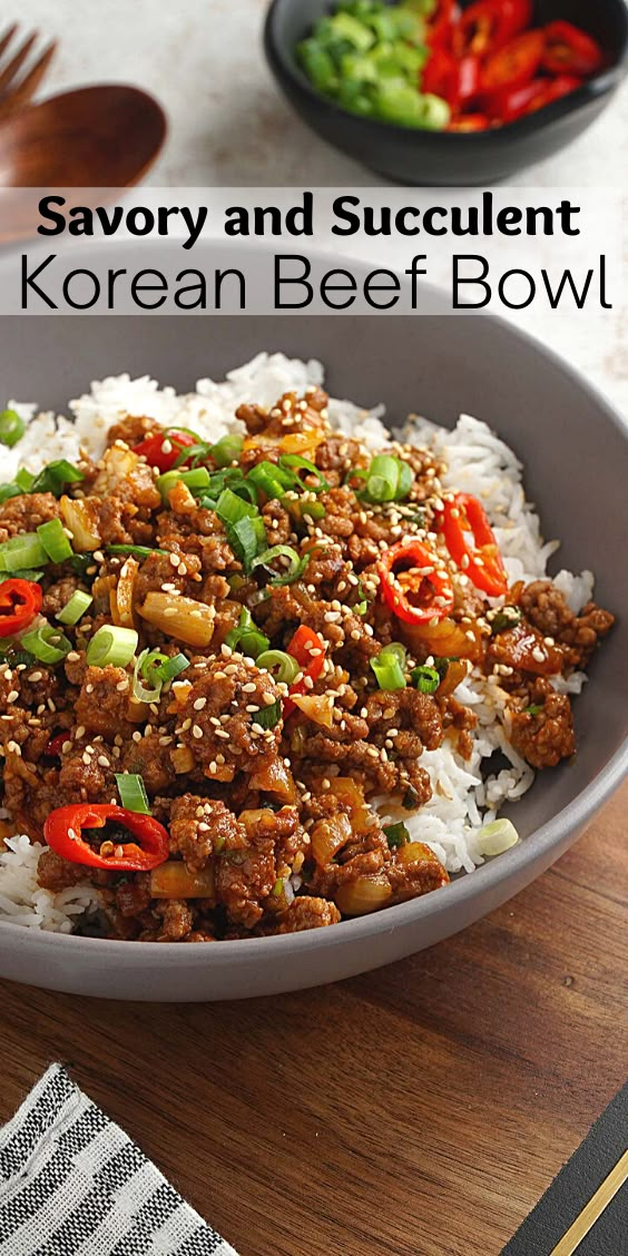 a bowl filled with beef and rice on top of a wooden table