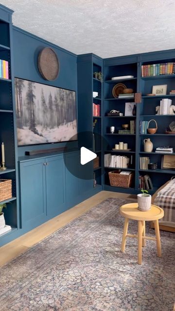 a living room with blue bookcases filled with books