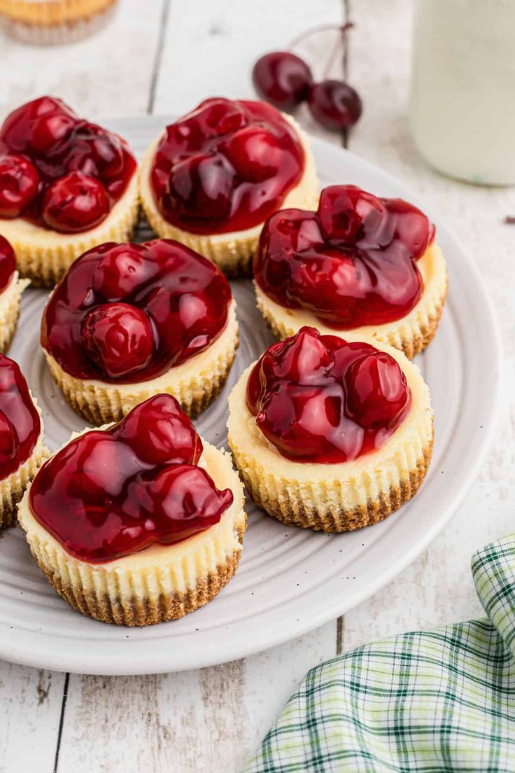 small tarts with cherries on a white plate