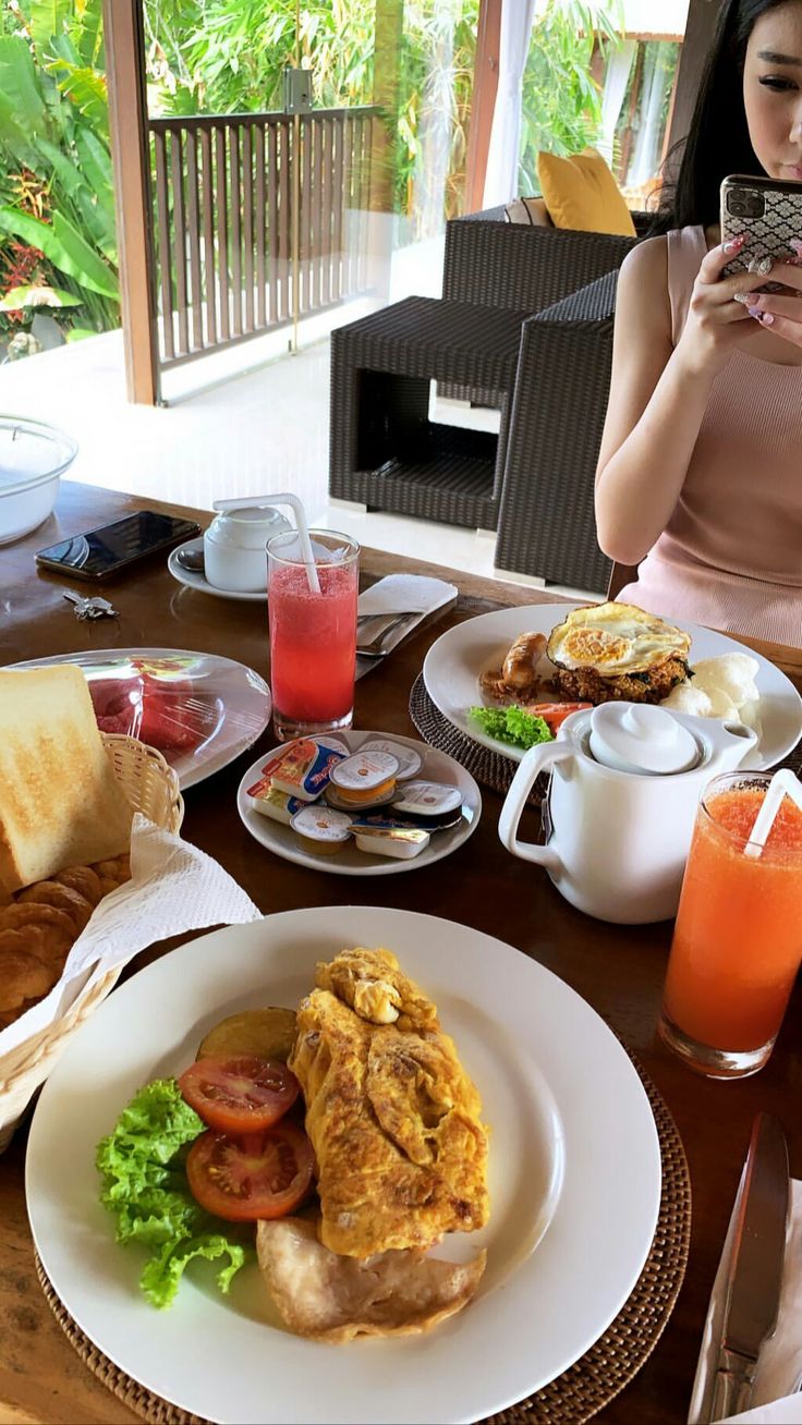 a woman taking a photo of her breakfast