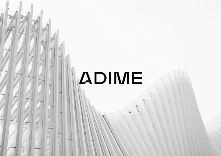 the words adme are displayed in front of a white building with lines on it