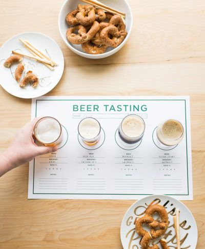 the beer tasting menu is displayed with pretzels in glasses and plates on the table