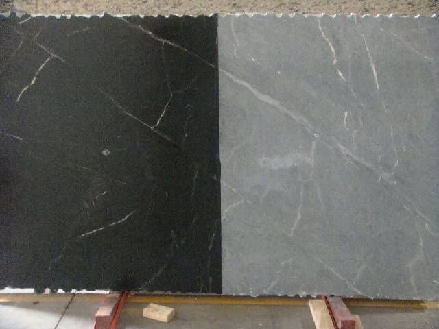 some black and grey marble tiles on the floor