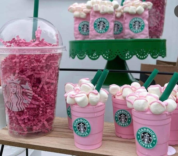 pink and white cupcakes in starbucks cups on a table