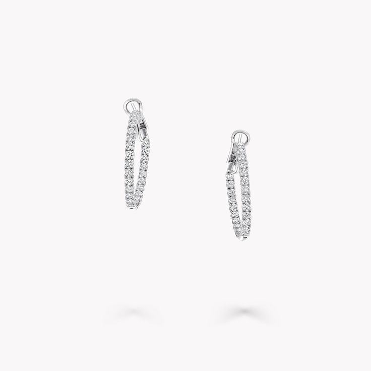 From the Classic Graff collection, our diamond hoop earrings in white gold are a twist on a timeless design. Cradled within a minimal white gold setting, each diamond radiates natural fire and exceptional brilliance. The Classic Graff collection features the finest Graff diamonds showcased in sleek, stylish silhouettes that you will wear time and time again. Available in a variety of different carat sizes. An elegant pair of Classic Graff round diamond hoop earrings with a total approximate weight of 3.17 carats. Graff Earrings, Graff Jewelry, Diamond Shaped Engagement Ring, Carat Sizes, White Diamond Jewelry, Graff Diamonds, Diamond Earrings Studs Round, Fine Diamond Jewelry, Engagement Ring Shapes