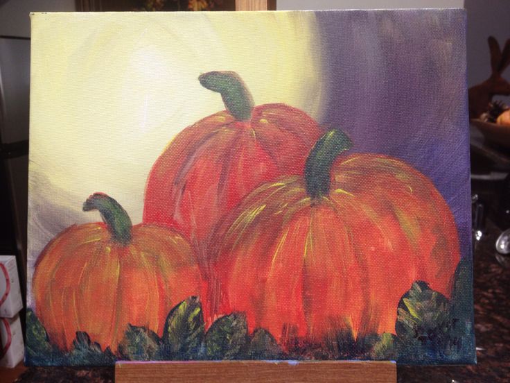 a painting of three pumpkins sitting on top of a counter