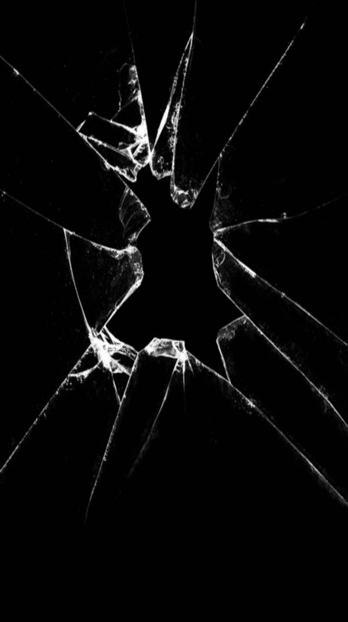 a broken glass window in the dark