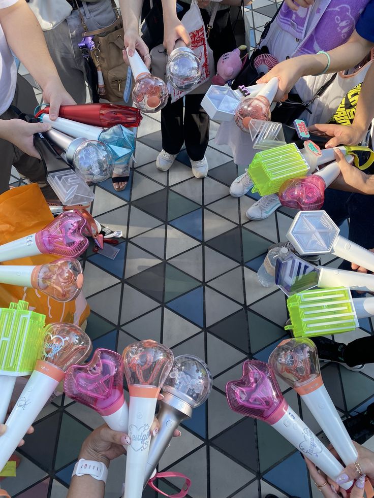 a group of people standing around each other with toothbrushes in their hands and on the ground