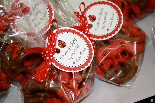 red and white cookies with ladybugs on them in plastic wrappers for sale