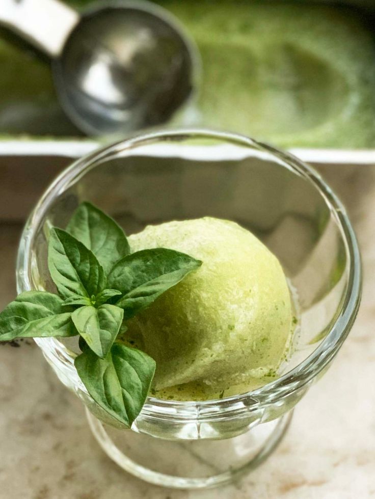 a glass bowl filled with green ice cream