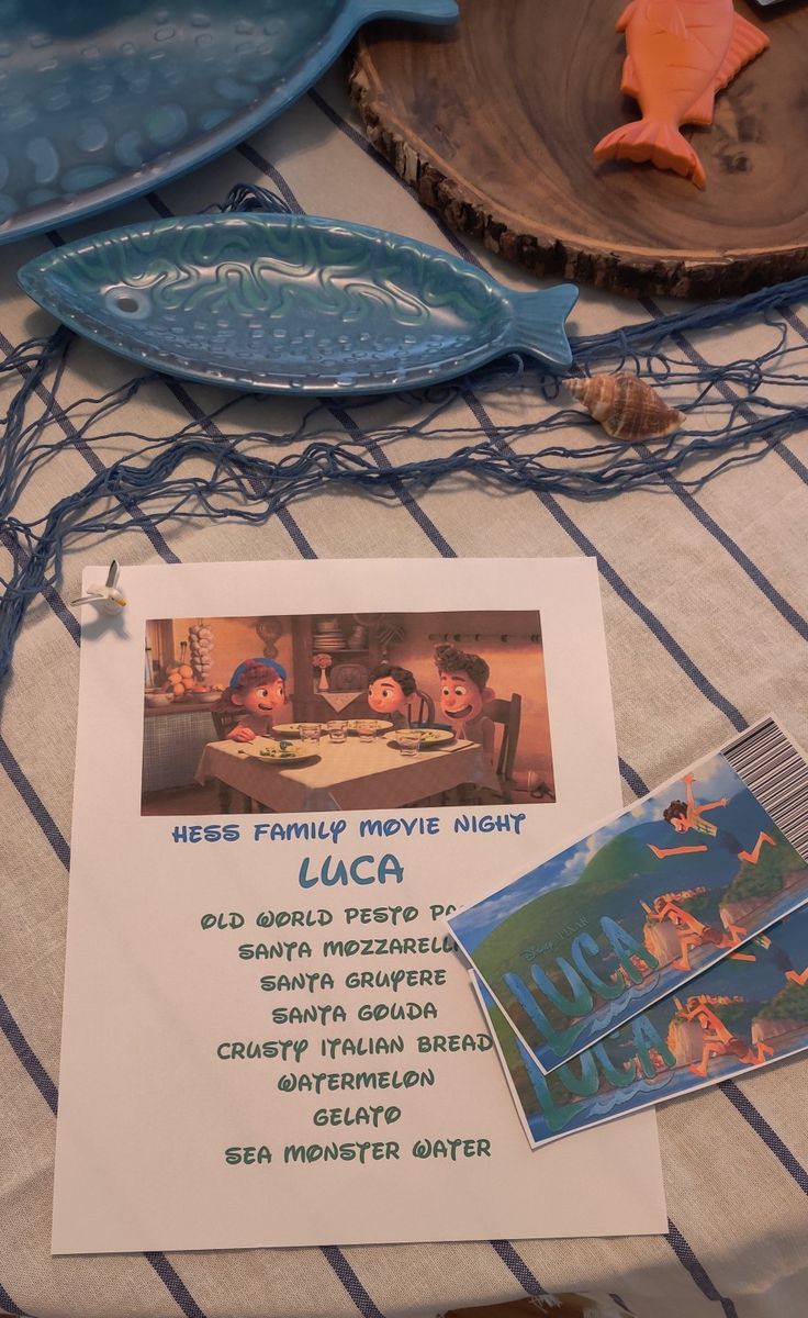 a table topped with plates and dishes covered in information about the disney pixama movie