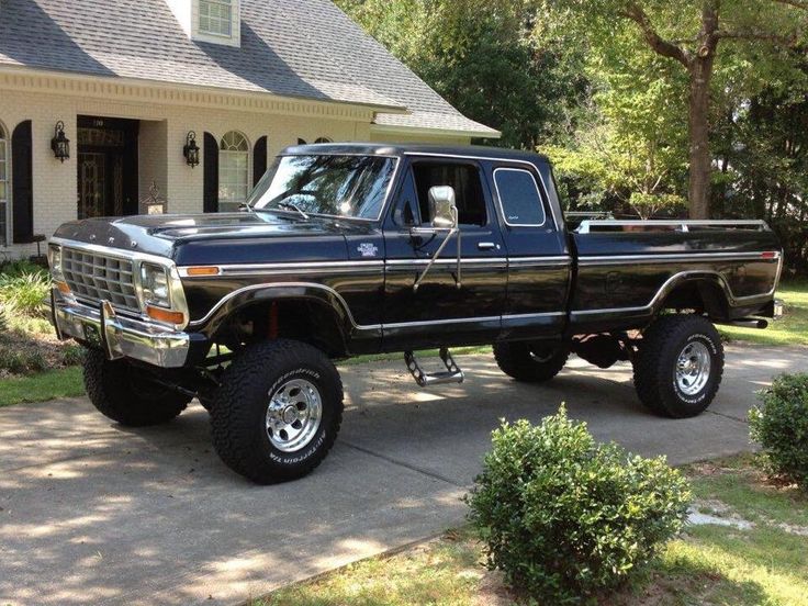 a black pickup truck parked in front of a house