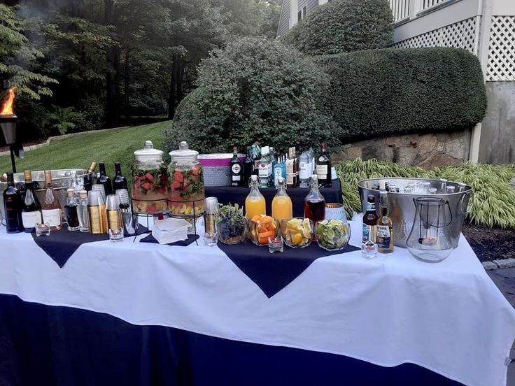 a table topped with lots of bottles and glasses