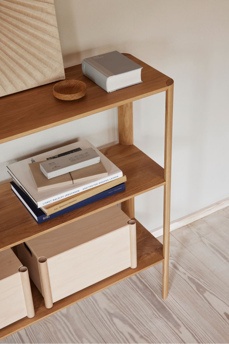 a wooden shelf with books and other items on it