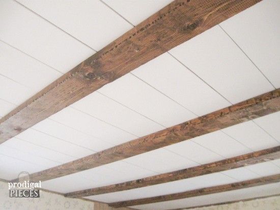 an unfinished wooden ceiling with white paint and wood slats