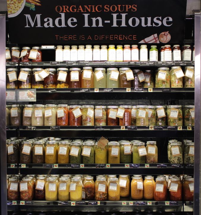 a display case in a store filled with lots of different types of sauces and condiments