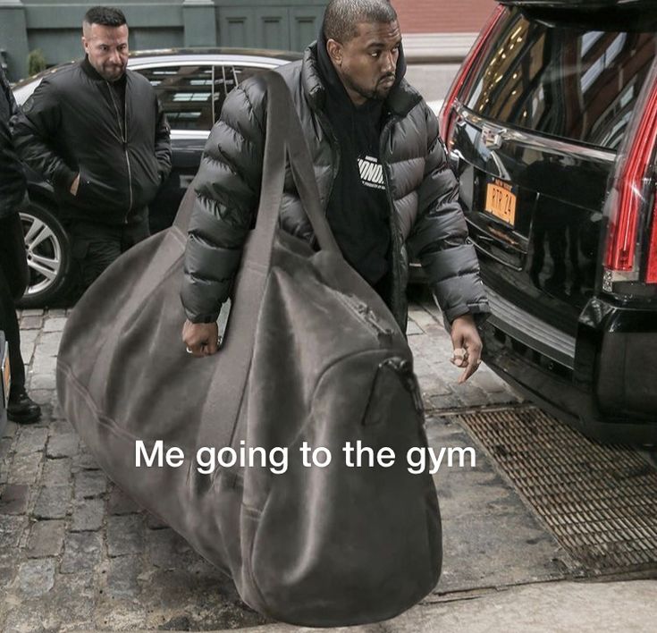 a man carrying a gym bag down the street