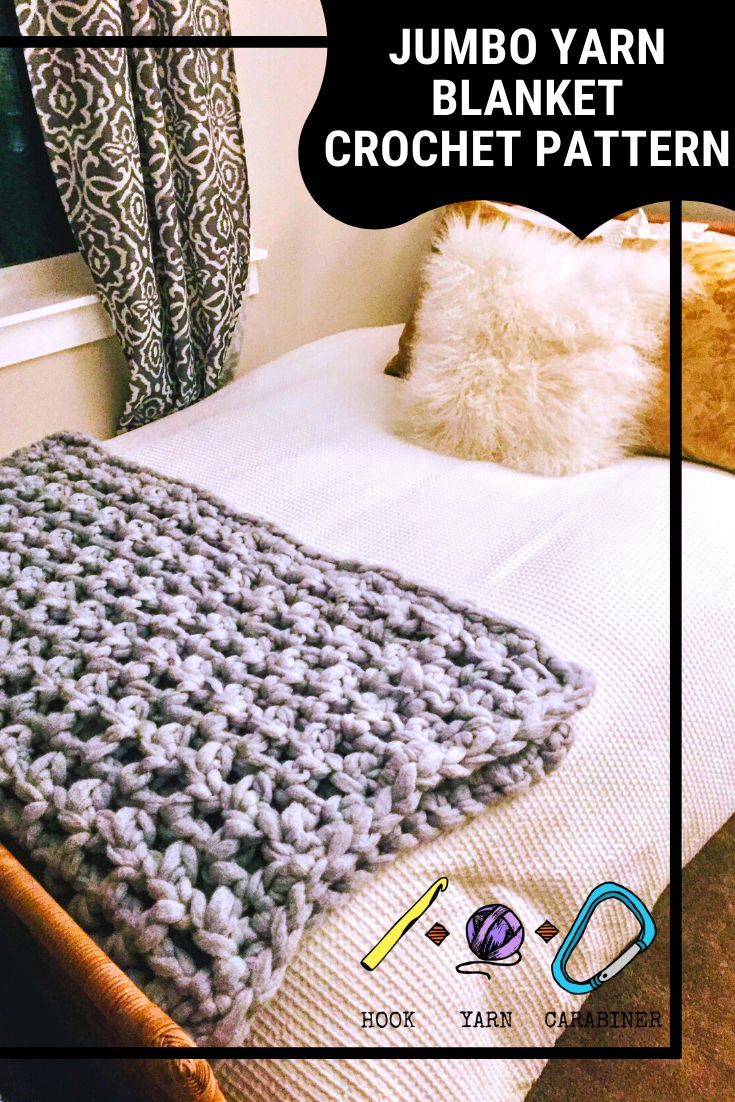 a crocheted blanket sitting on top of a bed next to pillows and a pillow