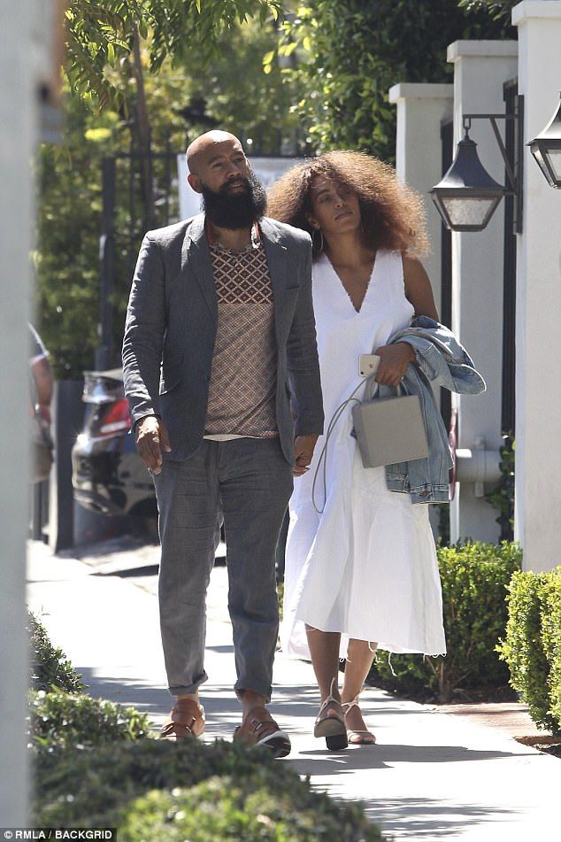 a man and woman walking down the street