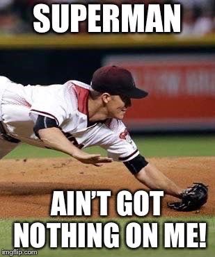 a baseball player dives into the ground to catch a ball with his glove on