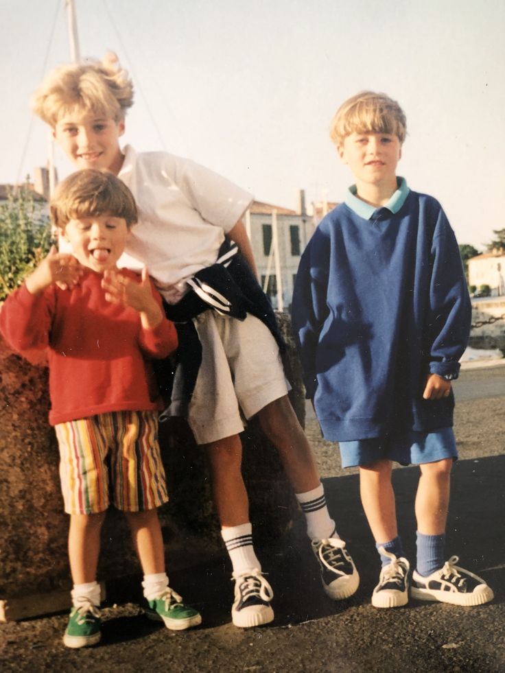 three young boys standing next to each other