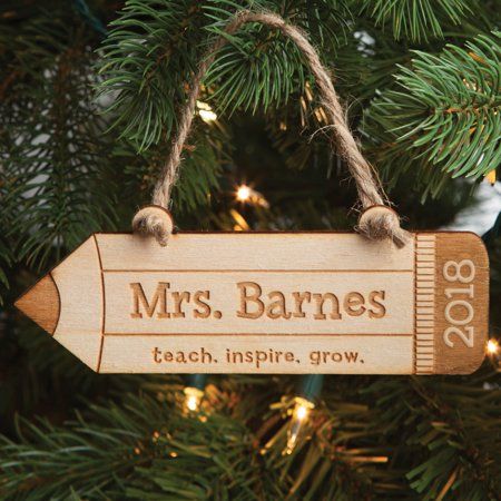 an ornament hanging from a christmas tree with the name mrs barnes on it