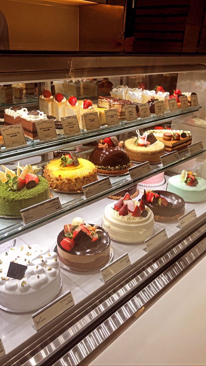 a display case filled with lots of different types of cakes