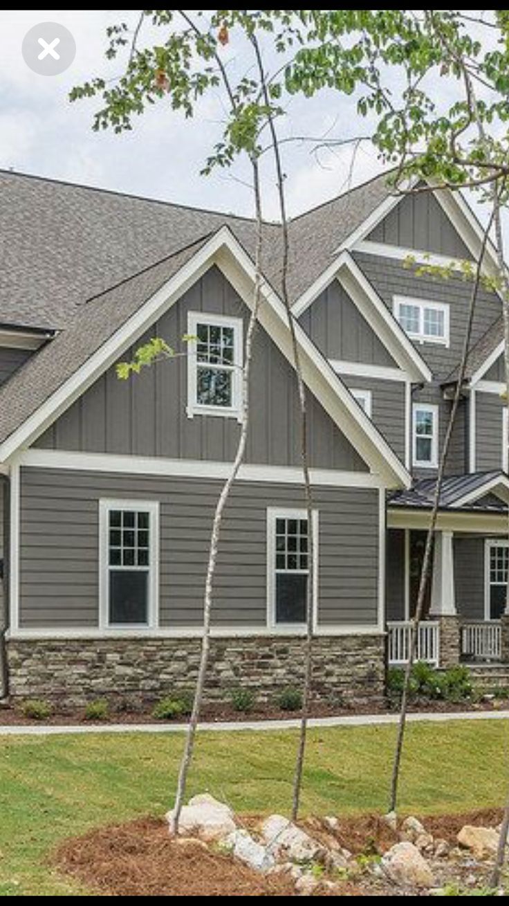 a large gray house with lots of windows