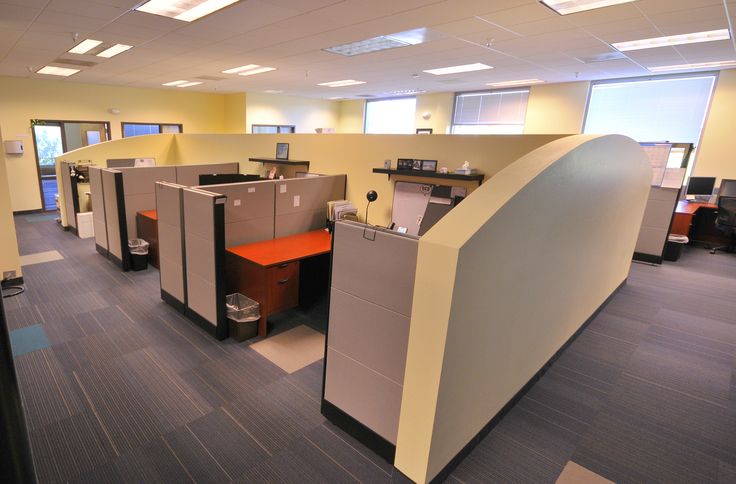 an office with cubicles and desks in it