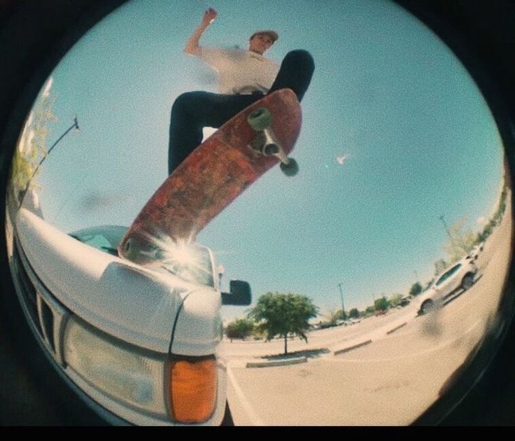 a man riding a skateboard on the back of a white truck