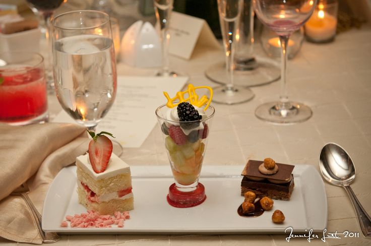 desserts and wine glasses on a table at a restaurant