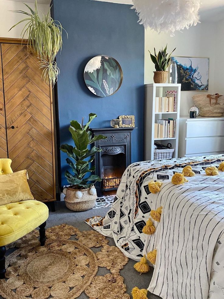 a bedroom with blue walls and rugs on the floor next to a yellow chair