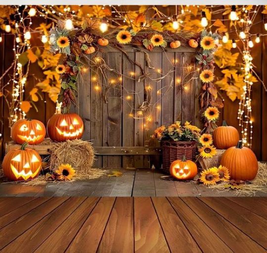 pumpkins and hay bales on a wooden floor in front of a fence with lights