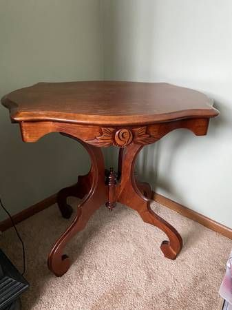 a wooden table sitting on top of a carpeted floor