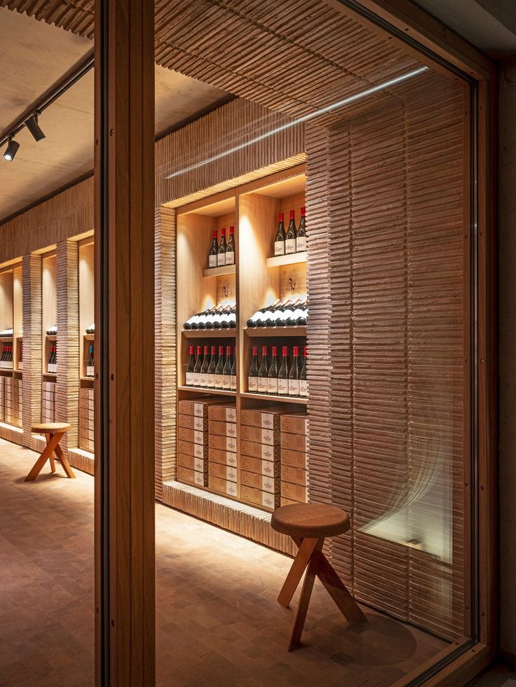 a wine store with wooden shelves filled with bottles