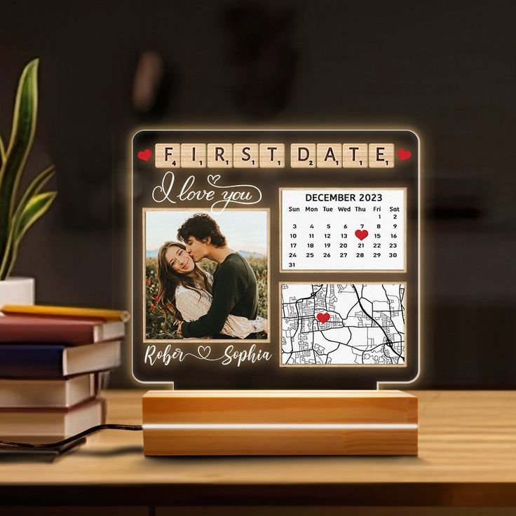 a desk top with a calendar on it and a couple's photo in the frame