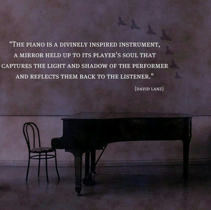 a piano sitting next to a chair with a poem written on the wall behind it