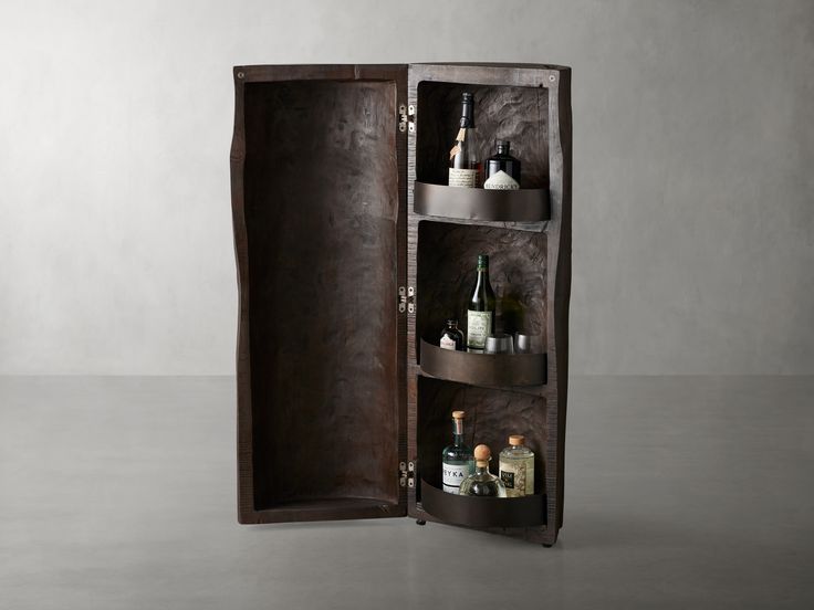 an open wooden cabinet with bottles in it