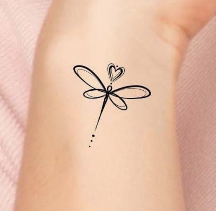 a small tattoo with a heart on the wrist and a dragonfly attached to it