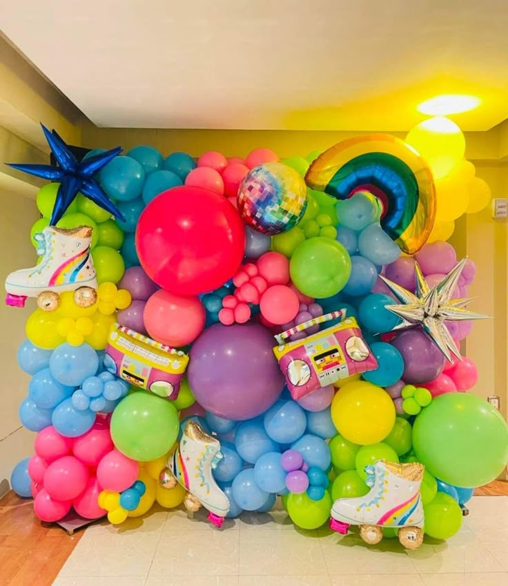 a bunch of balloons that are on the ground in front of a wall and floor