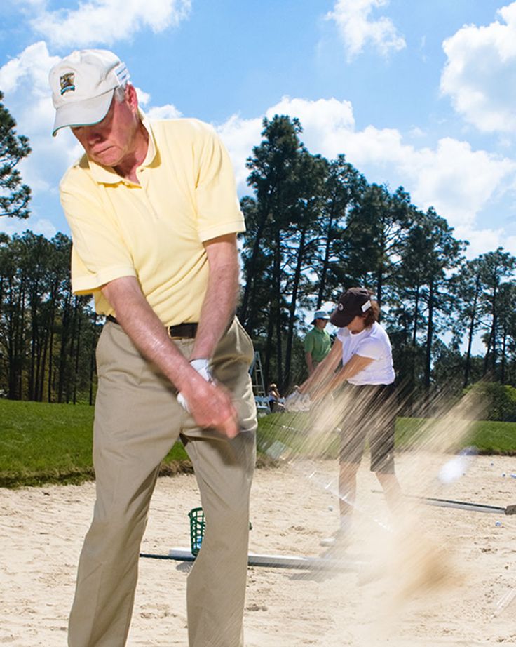 an older man is playing golf on the sand