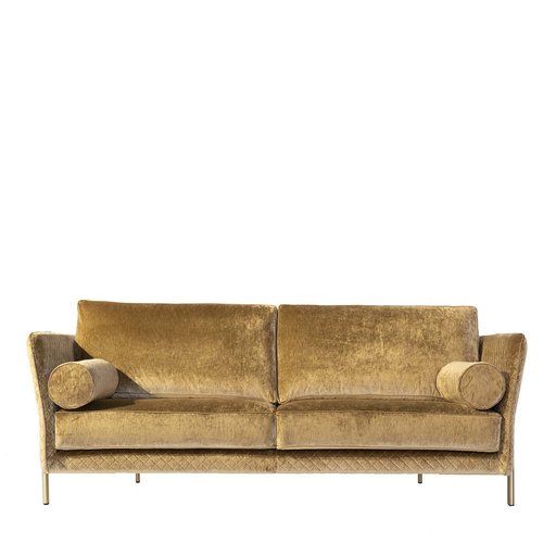 a gold colored couch with two pillows on it's arms and backrests